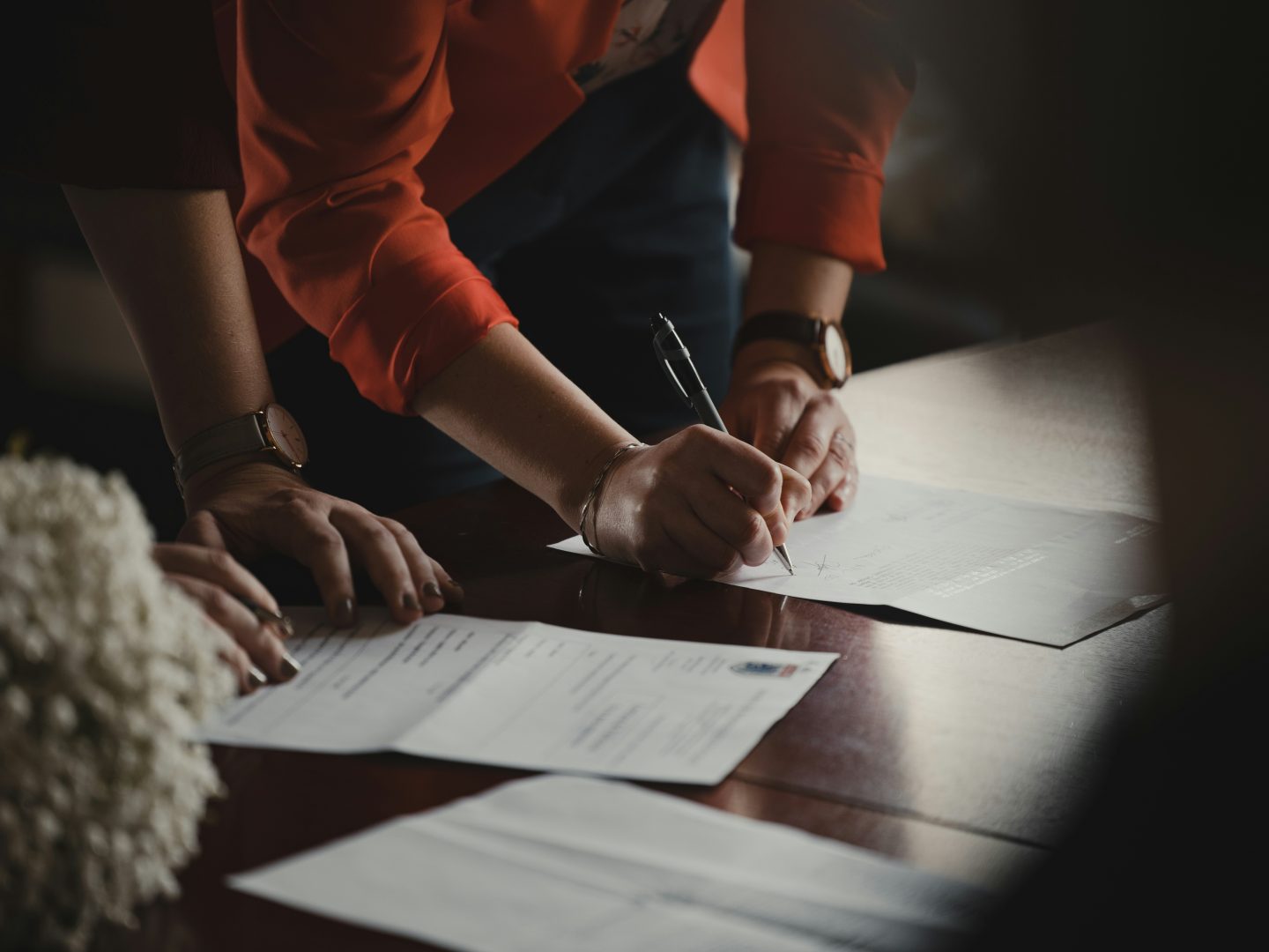 Clients signing documents with counsel